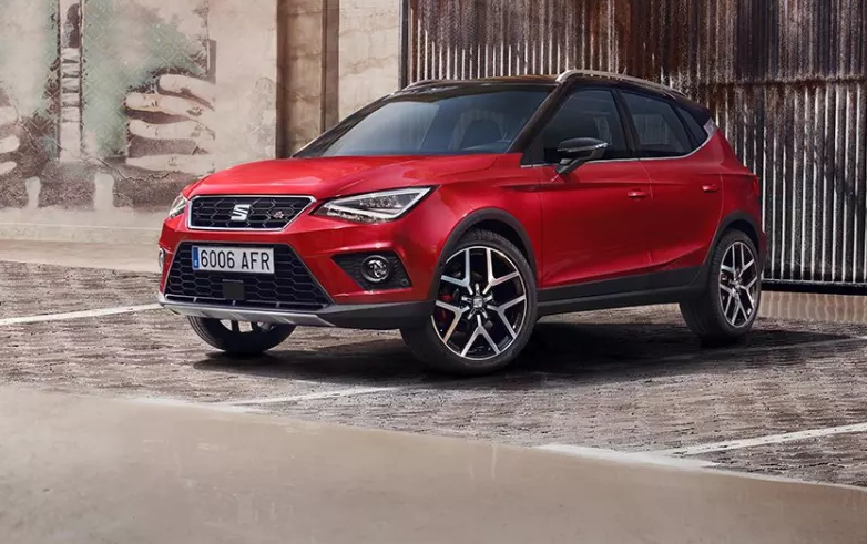 Red SEAT Arona parked two thirds front on cobbled street